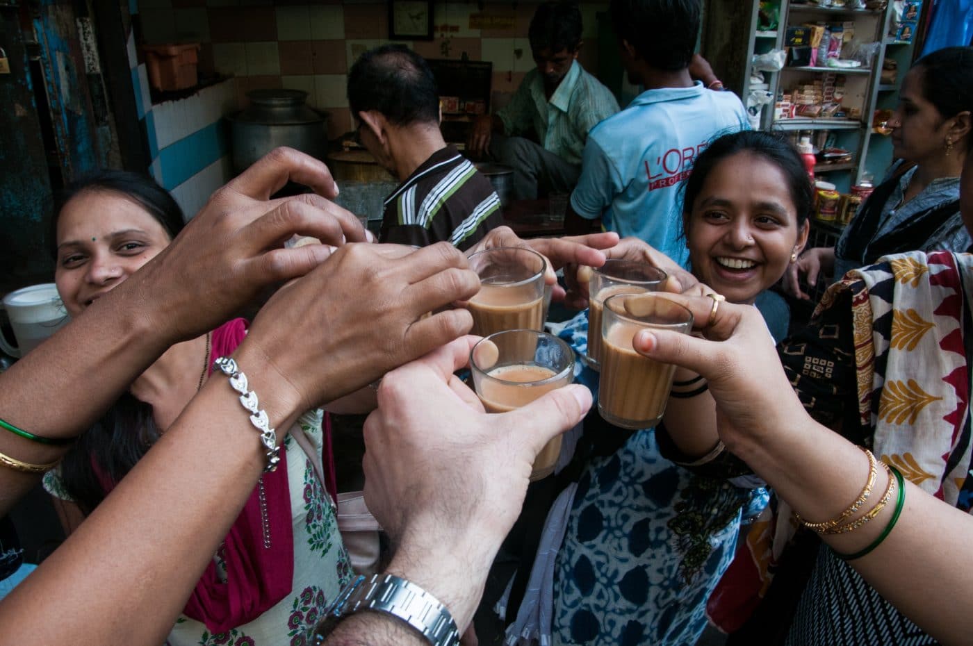 Women celebrate with a cheers and chai tea